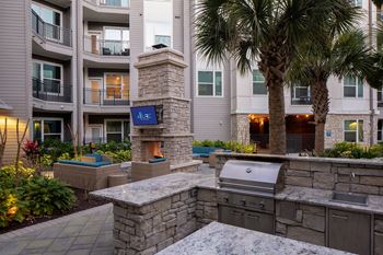An outdoor kitchen with a grill